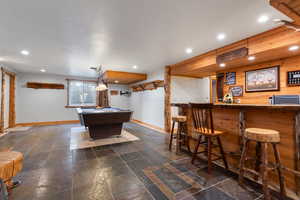 Recreation area off of family room with wet bar and pool table. Door to walk-out is on the left of photo