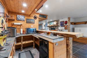 Bar area with mini fridge looking at fireplace area