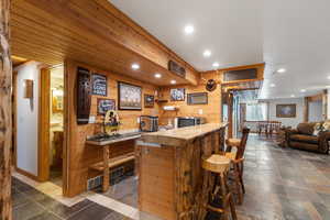 Wet bar could easily be converted into a kitchenette for a downstairs apartment. Plumbing and electrical are already there