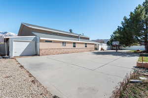 Industrial garage building. Smaller attached garage to the left has a door on both the east and west sides