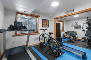 Exercise room showing open wall to the other side where a separate bedroom could be