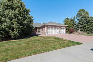 View (north east) of front entrance and side yards with mature trees