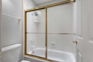 Full bath with enclosed tub and shower