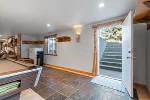 Recreation room walkout leading to the backyard and private parking to the right (from top of stairs)