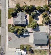 Drone/overhead view of house, outbuilding garage and separate driveway, pickleball/basketball court, and swimming pool