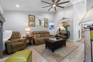 Second view of family room showing vaulted ceilings. Main entrance leading to the front door is on the right side of photo