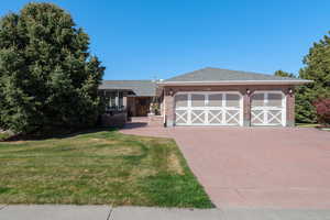 Front entrance daytime view - 3 car garage and stamped concrete driveway