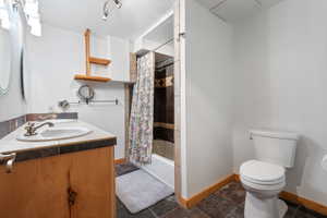 Bathroom #4 - Full bath featuring rustic vanity and slate tile floors