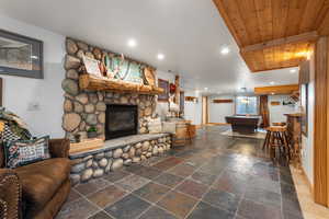 Recreation room view with wet bar to the right and pool table at the end