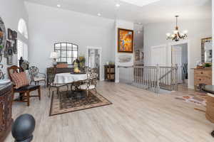 Dining area featuring huge vaulted ceilings and new, high-end laminate floors