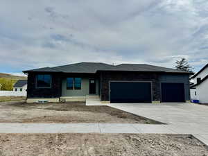 Prairie-style home with driveway and a garage
