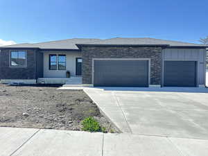 Prairie-style home with a garage, a shingled roof, and concrete driveway