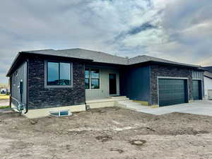 Prairie-style home with a garage and concrete driveway