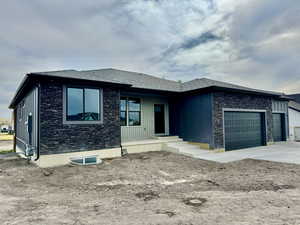 Prairie-style home with a garage and concrete driveway