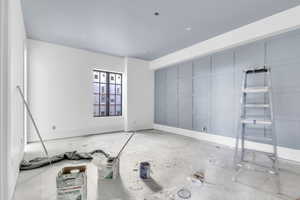 Unfurnished room with baseboards and concrete floors