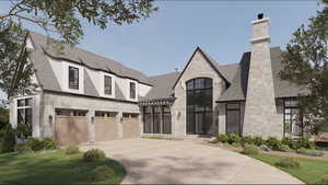 View of front of house featuring stone siding, driveway, and an attached garage