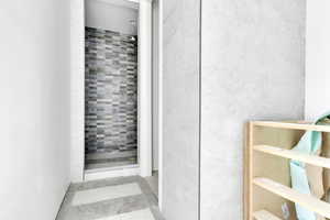 Bathroom featuring a stall shower and light tile patterned flooring