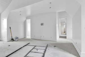 Bonus room featuring lofted ceiling and baseboards