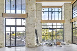 Entryway with a towering ceiling and healthy amount of natural light