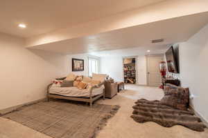 Bedroom with baseboards, visible vents, recessed lighting, and light colored carpet