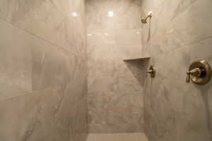 Room details featuring a tile shower