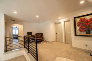 Office area with carpet floors, recessed lighting, and visible vents