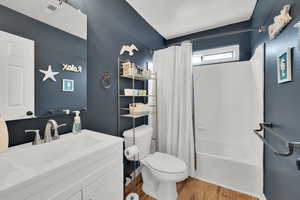 Full bathroom with toilet, vanity and shower / bath combination