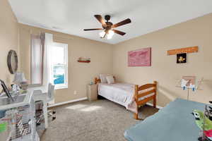 Carpeted bedroom with  ceiling fan