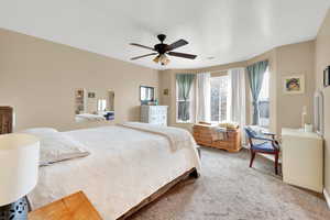 Master bedroom with carpet floors and a ceiling fan