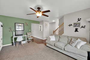 Carpeted living room with arched walkways