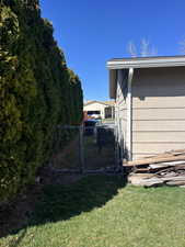 View of yard featuring a gate and fence