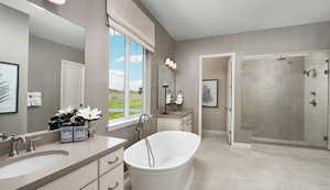Bathroom featuring a stall shower, a sink, two vanities, a soaking tub, and baseboards