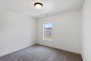 3rd bedroom, Empty room featuring baseboards, carpet flooring, and visible vents