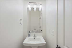 Half bathroom featuring a sink and toilet