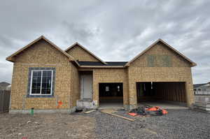 Property under construction featuring fence and an attached garage