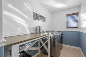 Laundry area with washing machine and clothes dryer, baseboards, laundry area, and tile patterned flooring
