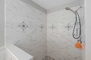 Full bathroom featuring a tile shower