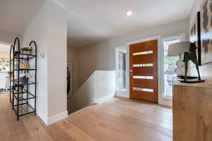 Entryway featuring baseboards, wood finished floors, and recessed lighting