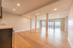 Family Room in basement with amazing west views of the valley.  Walk out to covered patio and backyard