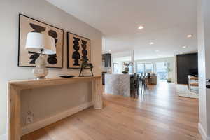 Hall featuring recessed lighting, light wood finished floors, and baseboards