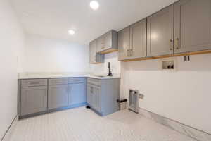 Beautiful new laundry room with new cabinetry, soft close and quartz counter tops