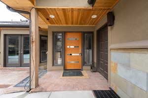 Entrance to property featuring french doors and stucco siding