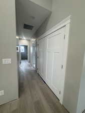 Hall featuring visible vents and wood finished floors