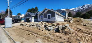 View of side of home with stone siding, board and batten siding, and a mountain view