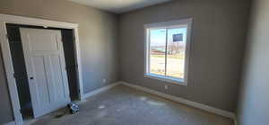 Unfurnished bedroom with baseboards