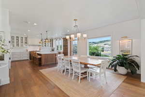 Dining space featuring hardwood / wood-style floors, an inviting chandelier, and recessed lighting