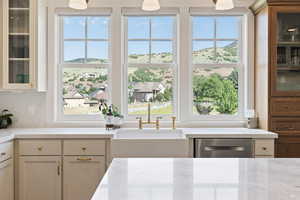 Kitchen with glass insert cabinets, white cabinetry, a sink, and dishwasher