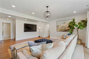 Living area featuring recessed lighting, baseboards, and light wood-type flooring