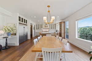 Dining space featuring visible vents, a chandelier, baseboards, recessed lighting, and dark wood-type flooring