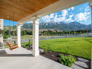 View of patio featuring a rural view, fence, and a mountain view